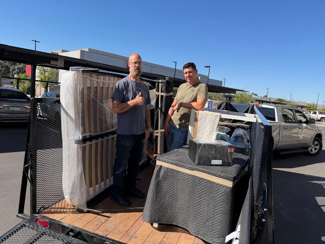 Linkus Movers team loading furniture on trailer in Mesa, AZ